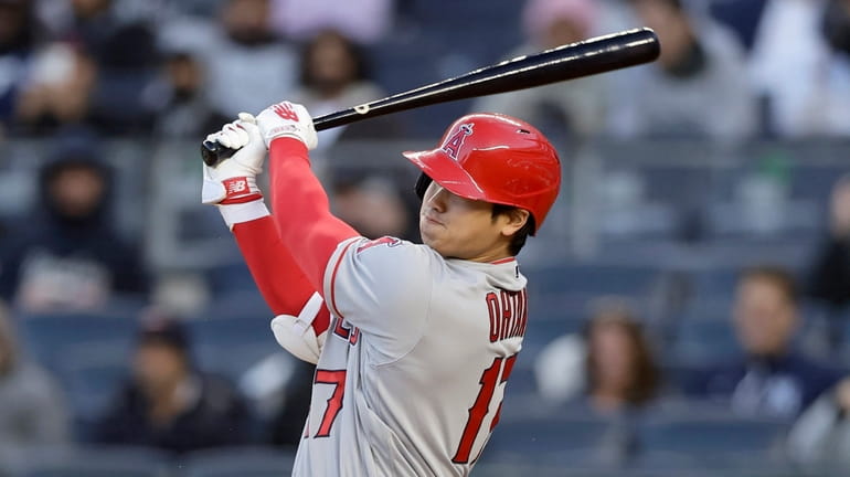 Shohei Ohtani #17 of the Los Angeles Angels follows through...