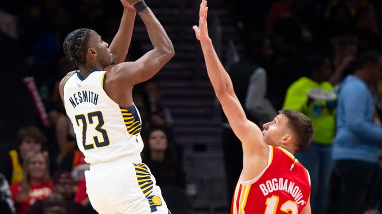 Indiana Pacers forward Aaron Nesmith shoots over Atlanta Hawks guard...