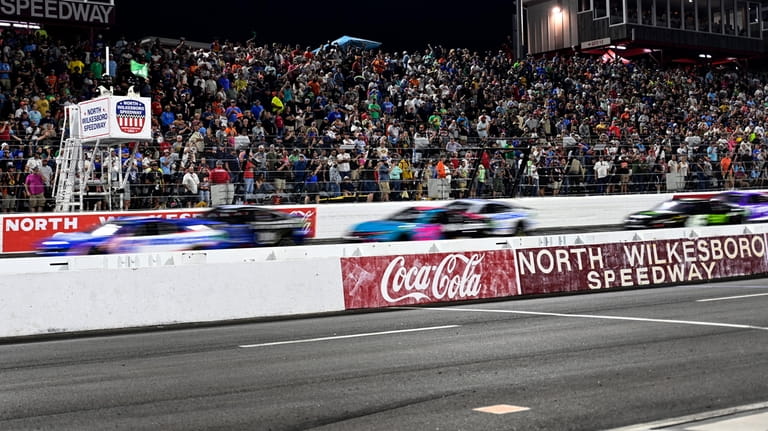 A pack of cars take a green flag restart during...