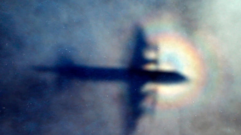 The shadow of a Royal New Zealand Air Force P3...
