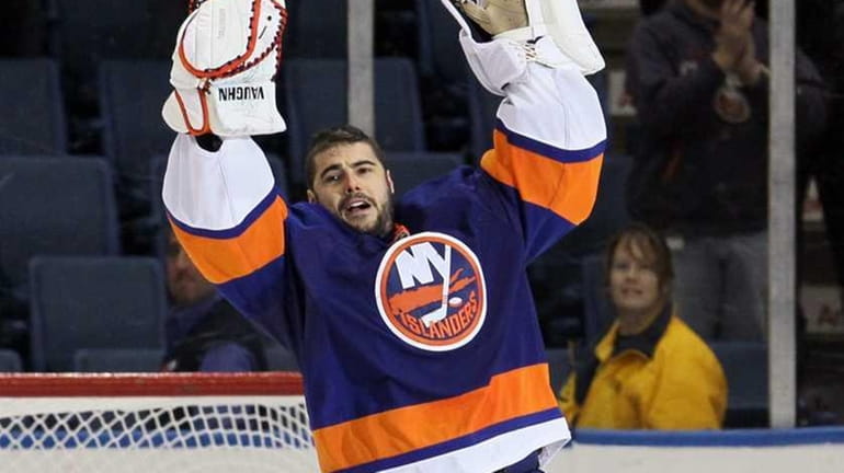 Islanders goalie Rick DiPietro celebrates after defeating the Pittsburgh Penguins...