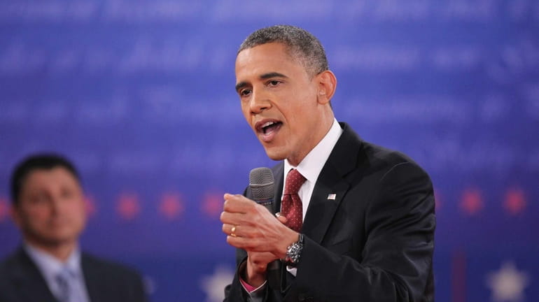 President Barack Obama answers a question during a town hall...
