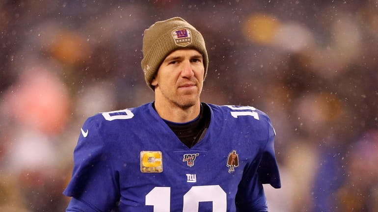 Eli Manning #10 of the Giants runs off the field...