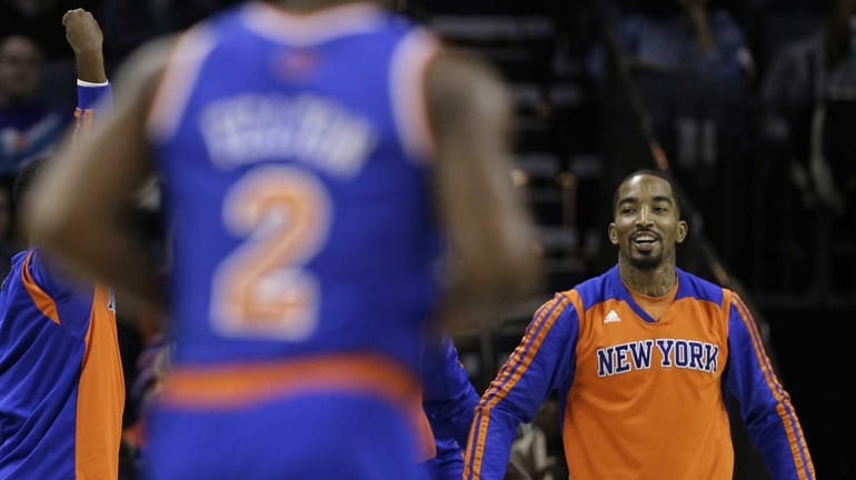 J.R. Smith, right, smiles after Raymond Felton (2) made a...
