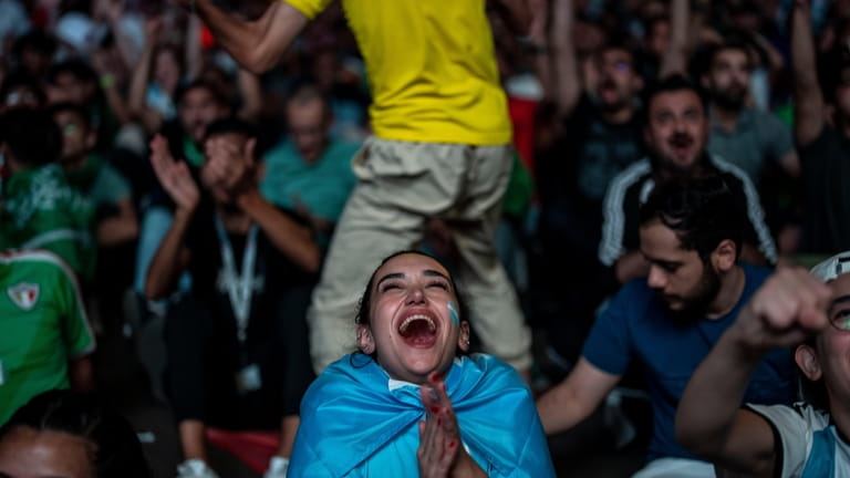 A fan of Argentina reacts after Argentina's Lionel Messi scores...