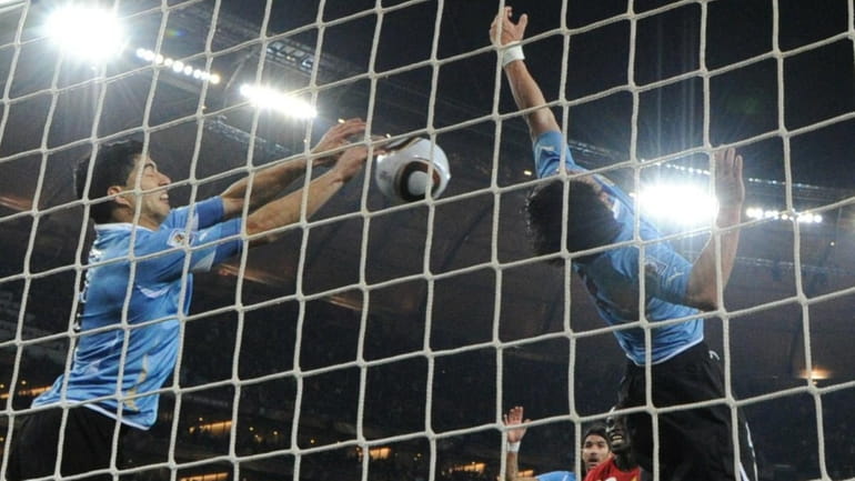 Uruguay's striker Luis Suarez, left, stops the ball with his...