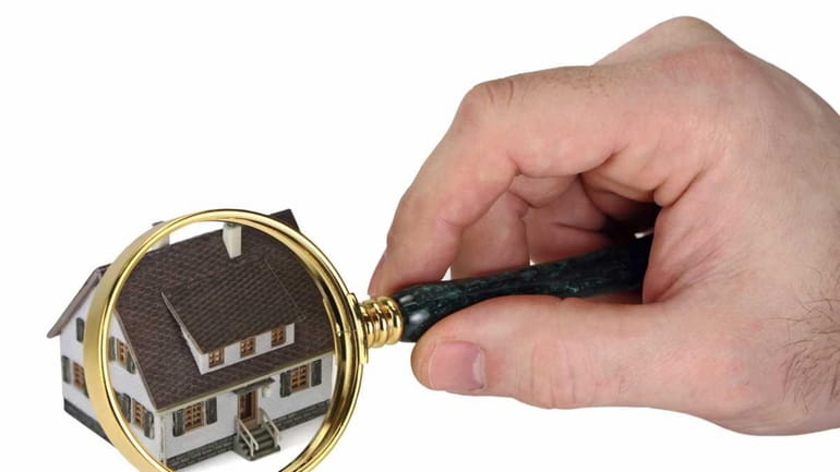 Concept image of a home inspection. A male hand holds...