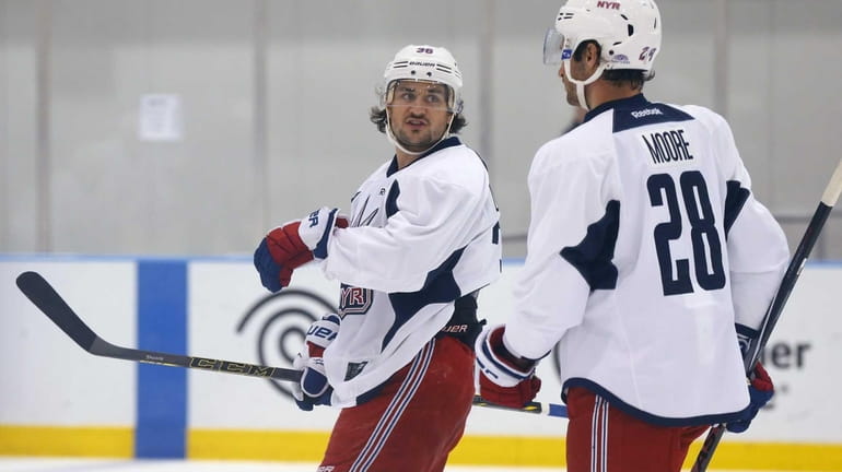 Mats Zuccarello and Domininc Moore talk during training camp on...