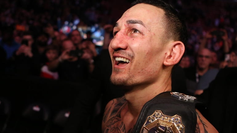 Champion Max Holloway leaves the octagon after defeating Brian Ortega...