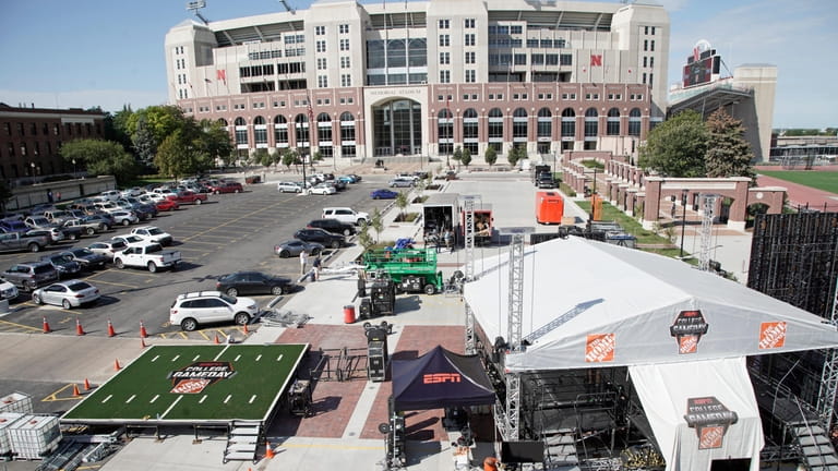Workers set up the ESPN "College GameDay" stage in front...