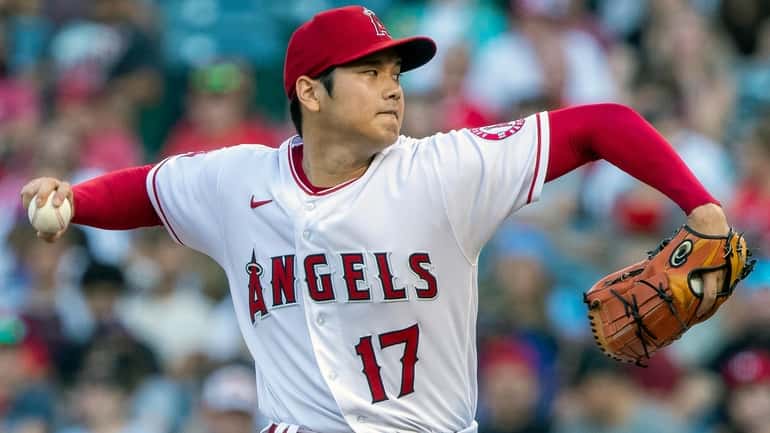 Angels starting pitcher Shohei Ohtani throws to a Texas Rangers...