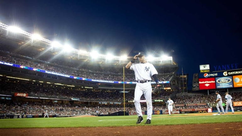 Derek Jeter walks back toward the dugout at Yankee Stadium....
