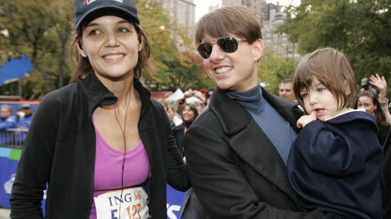 Katie Holmes joins Tom Cruise as he holds their daughter,...