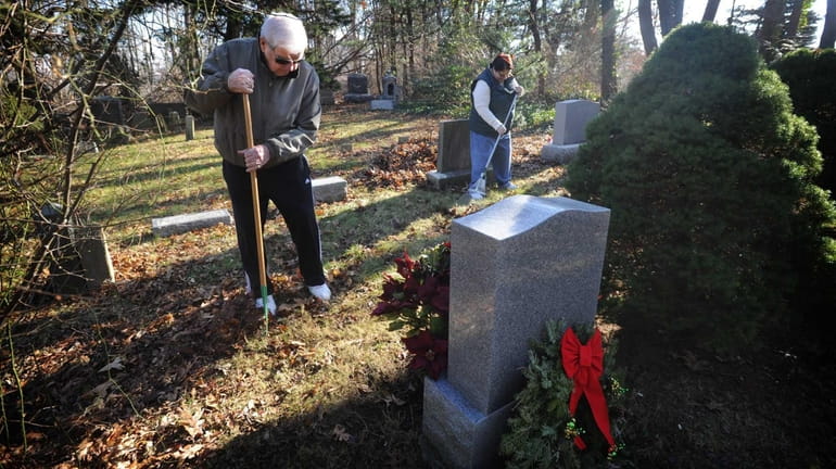 Debbie Bolton, right, and her father Nelson, left, clean up...