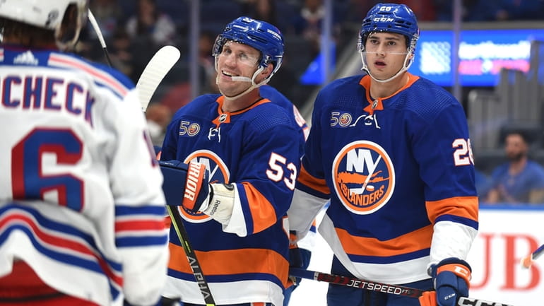Casey Cizikas of the New York Islanders, center, and teammate...
