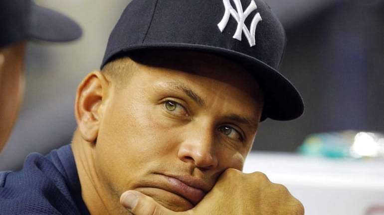 Alex Rodriguez looks on from the dugout during a game...