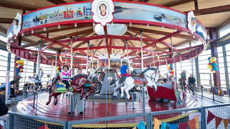 The Greenport Carousel in Mitchell Park, built in 1920, has views...