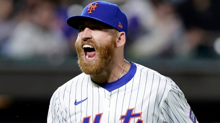Reed Garrett of the New York Mets reacts after getting the...
