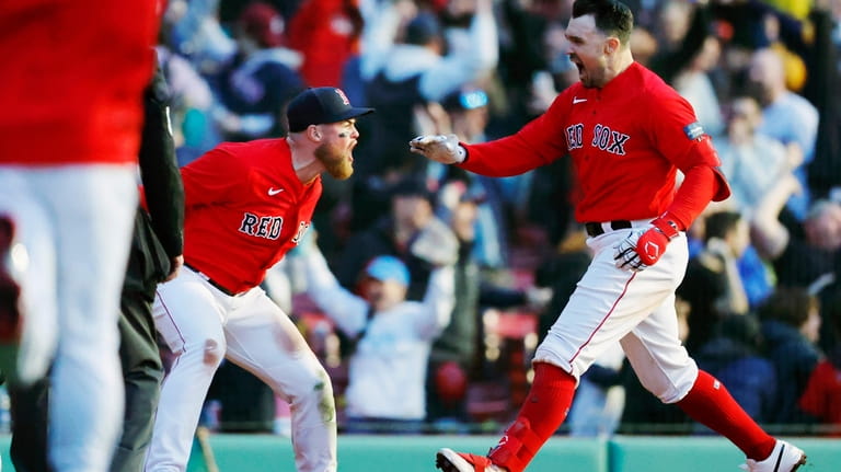 Boston Red Sox's Christian Arroyo, left, greets Adam Duvalll, right,...