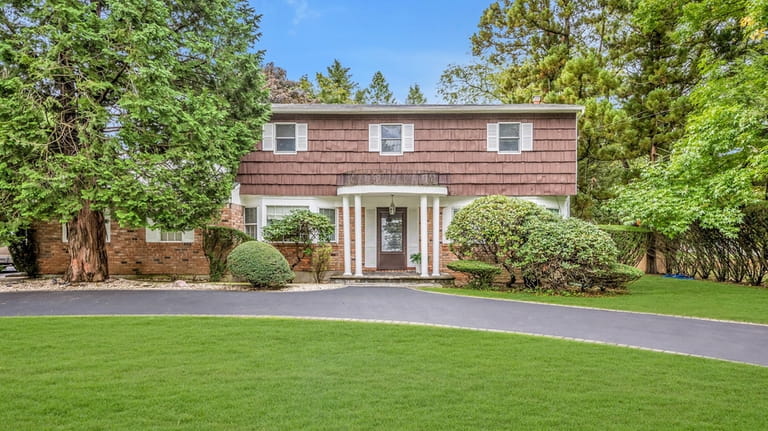 Priced at $729,000, this center-hall Colonial on Burr Road has...