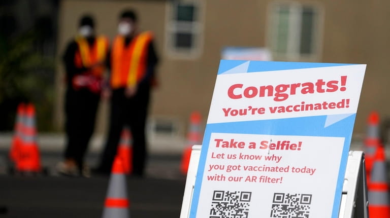 A selfie station congratulates people for getting vaccinated at a...