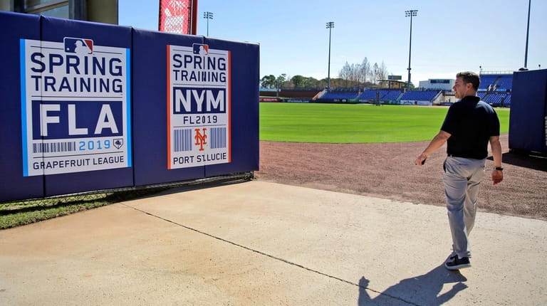 Mets general manager Brodie Van Wagenen walks through an outfield...