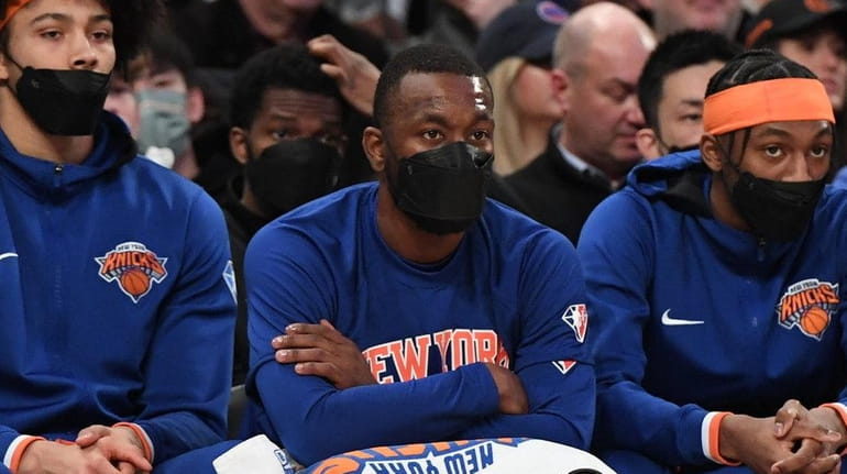 Knicks guard Kemba Walker, center, looks on from the bench...