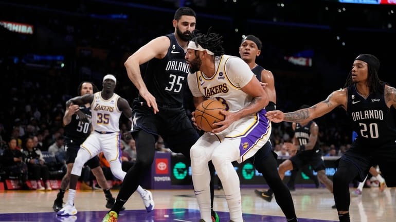 Los Angeles Lakers forward Anthony Davis (3) is defended by...