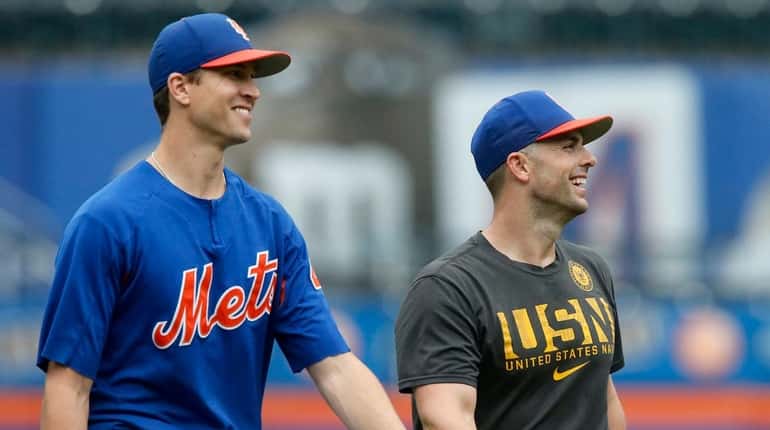 David Wright and Jacob deGrom of the Mets talk during...
