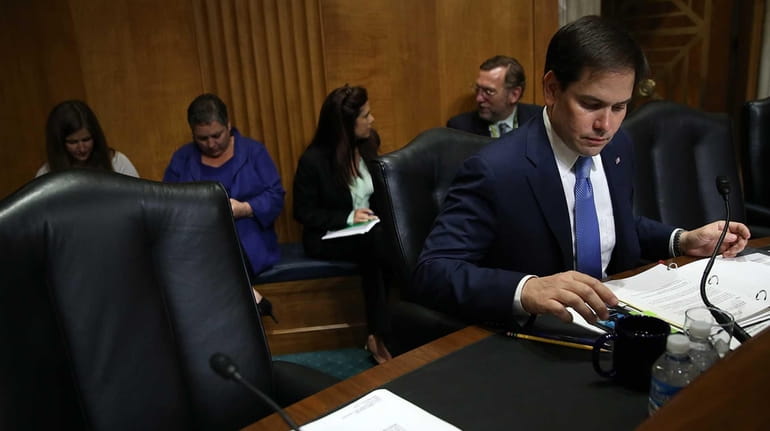 Republican presidential candidate Sen. Marco Rubio prepares to question Assistant...