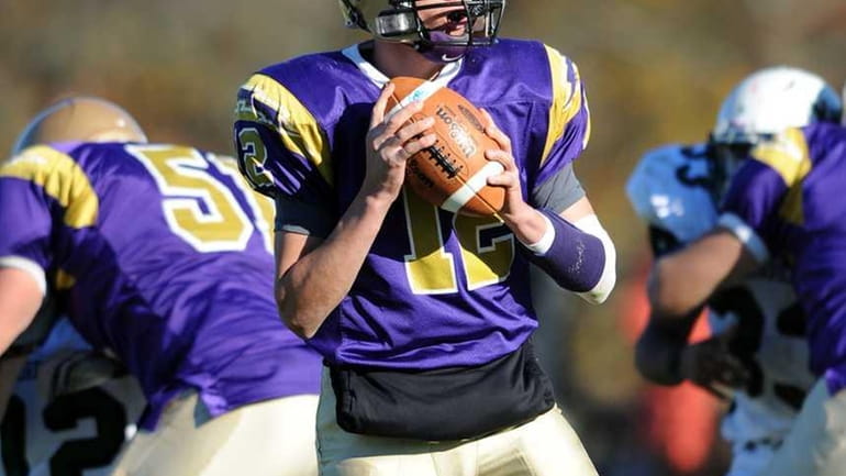 Sayville Steven Ferreira looks down field to pass in the...