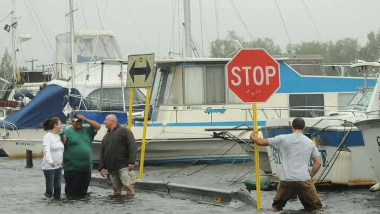 Residents check on their boats on Shore Road in Babylon...