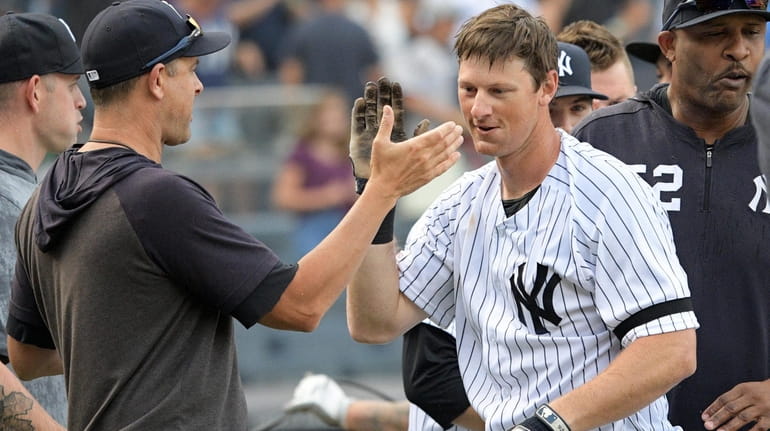 DJ LeMahieu is congratulated by Yankees manager Aaron Boone after...