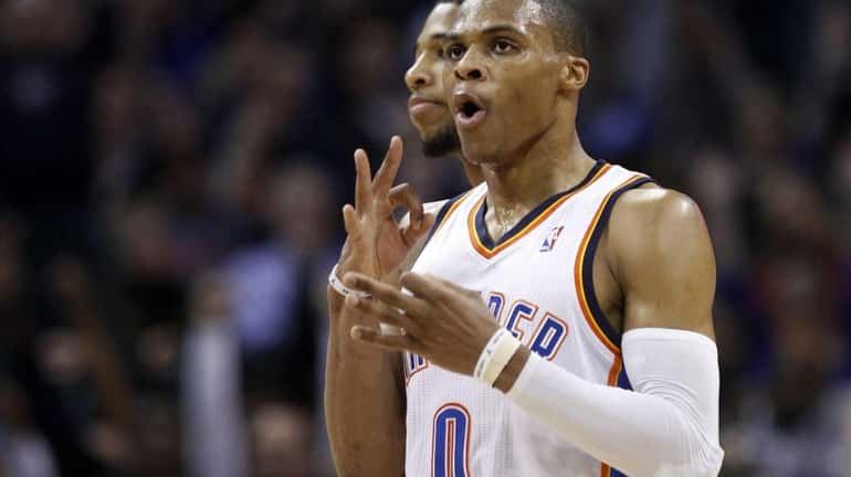 Oklahoma City Thunder guard Russell Westbrook gestures after hitting a...