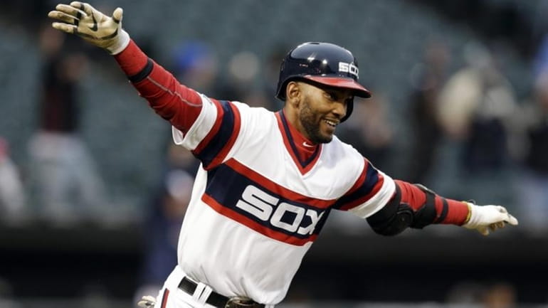 Chicago White Sox's Alexei Ramirez celebrates as he rounds the...