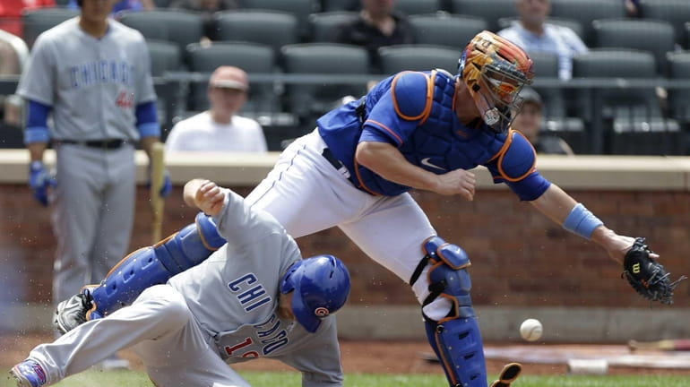 Chicago Cubs outfielder Nate Schierholtz scores on a Mets' throwing...