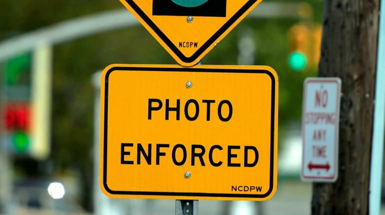 Photo of the red light traffic camera sign at the...