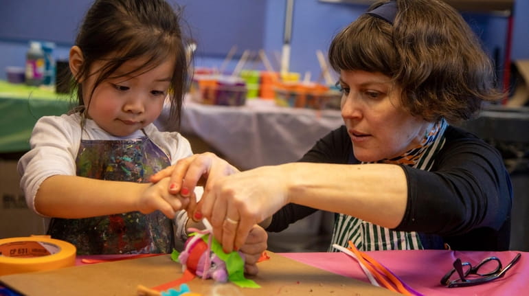 Harper Liao, 4, Brooklyn,works with artist Julie Peppito as she...
