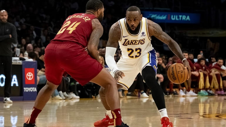 Los Angeles Lakers forward LeBron James (23) dribbles against Cleveland...