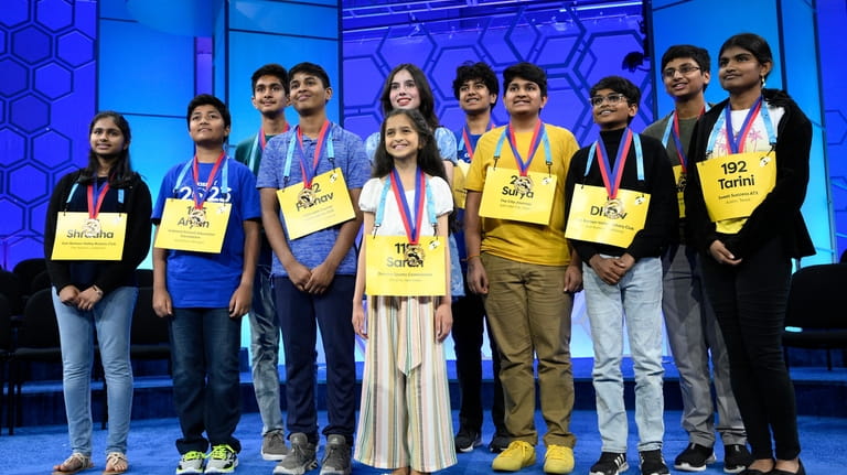 The 11 finalists for the Scripps National Spelling Bee pose...