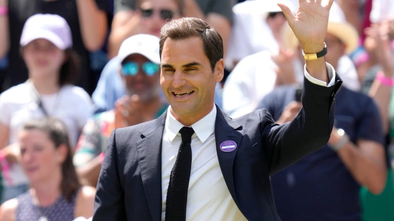 Roger Federer waves during a 100 years of Centre Court...