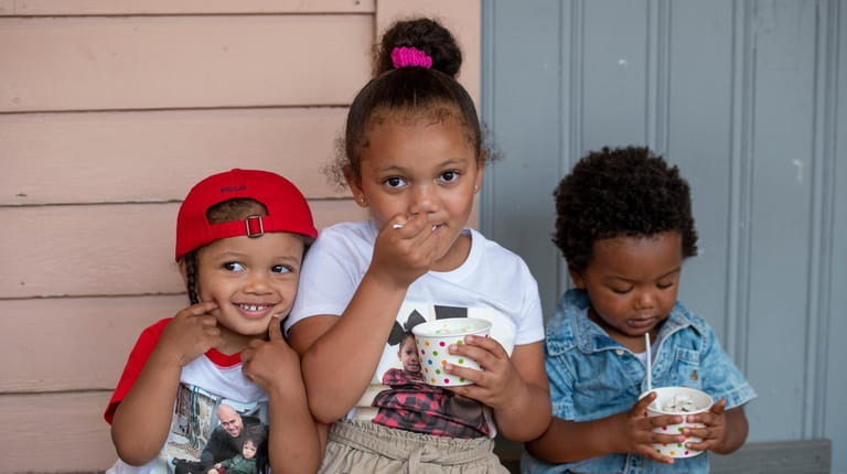 Kennedy, 5, and Carson Williams, 2, have ice cream with Micah Pierce,...