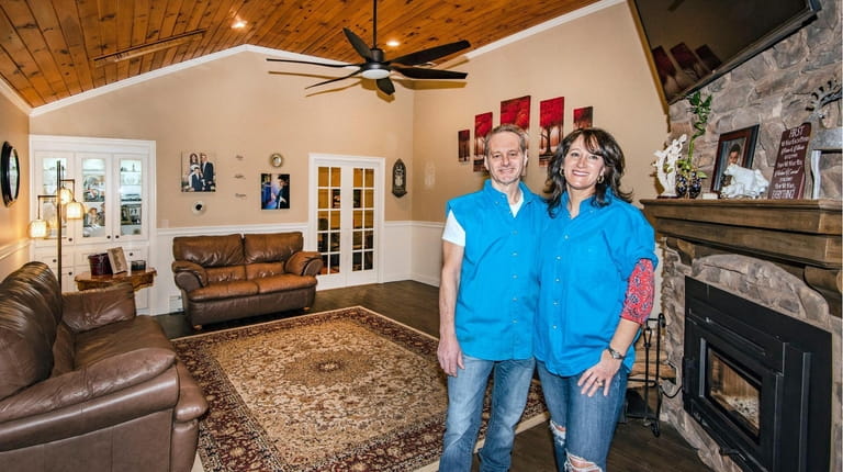 Brian and Maria Neglia stand in their living room in...
