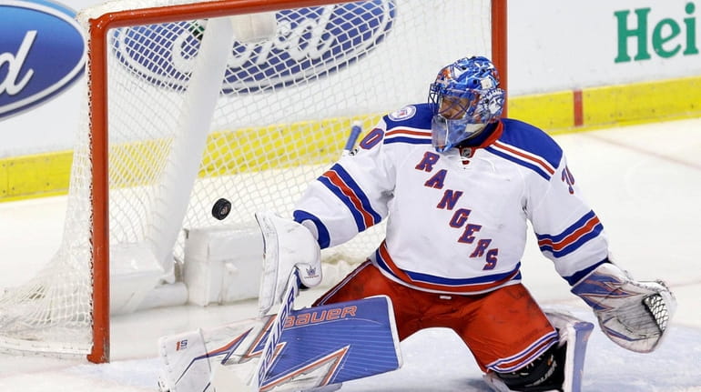 New York Rangers goalie Henrik Lundqvist (30) deflects a shot...