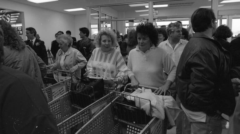 Crowds of customers enter the first Kmart store on Long Island,...