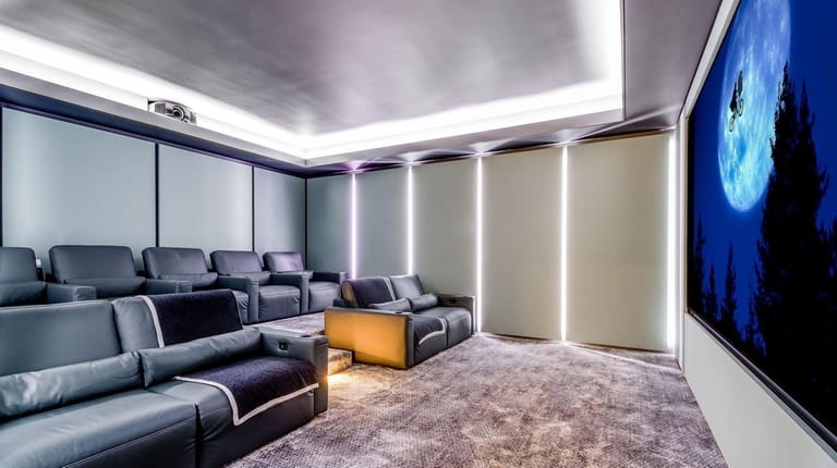 The house has a lower-level custom-designed home theater with seating...