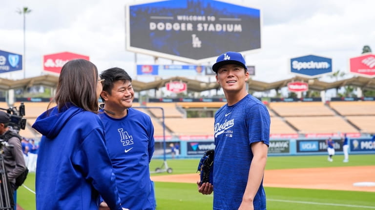 Los Angeles Dodgers pitcher Yoshinobu Yamamoto looks around Dodger Stadium...
