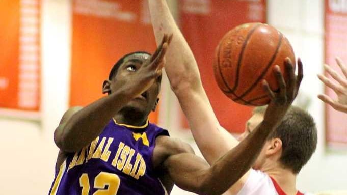 Central Islip's Timothy McKenzie goes baseline for two against East...