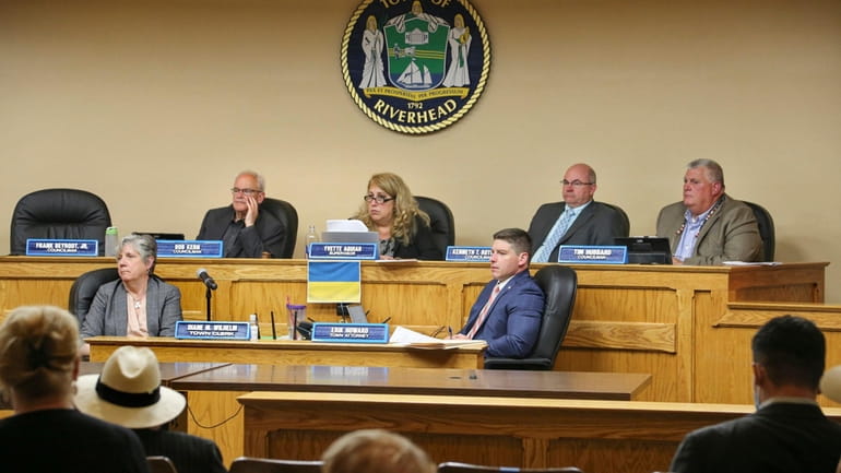 Riverhead Town Board members listen during a public hearing on...