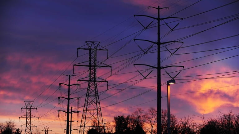 Power lines seen at sunrise in Melville on Jan. 11,...